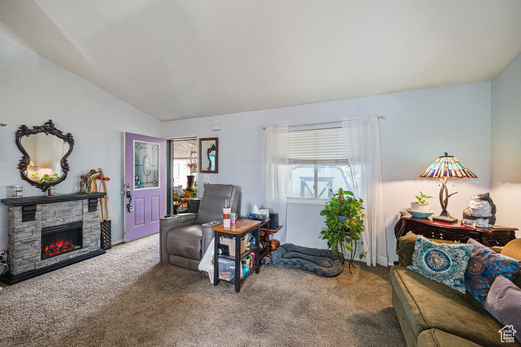 Carpeted office with vaulted ceiling and a fireplace