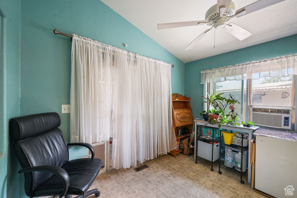 Home office featuring lofted ceiling, ceiling fan, and cooling unit