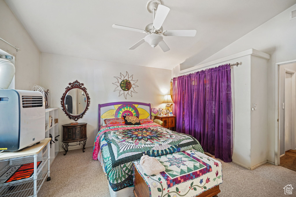 Bedroom featuring carpet flooring, ceiling fan, and vaulted ceiling