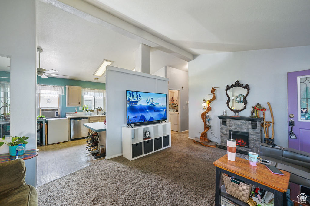 Living area featuring a fireplace, light colored carpet, a ceiling fan, and cooling unit