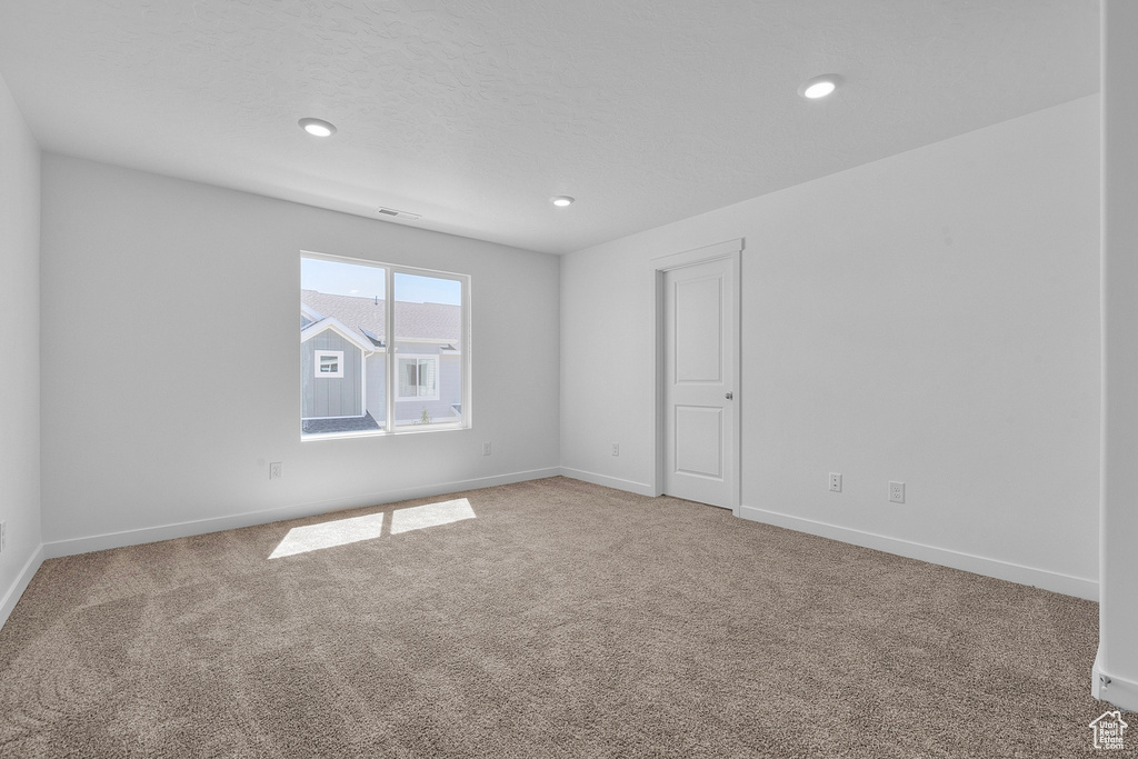 Spare room featuring carpet flooring and recessed lighting