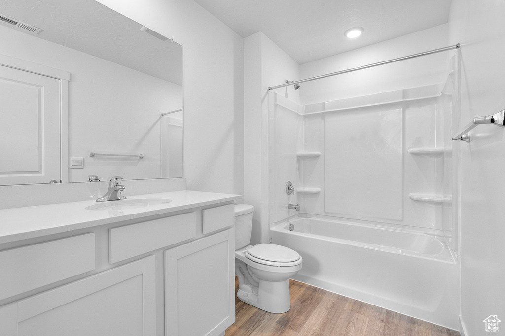 Full bathroom featuring bathtub / shower combination, vanity, and wood finished floors