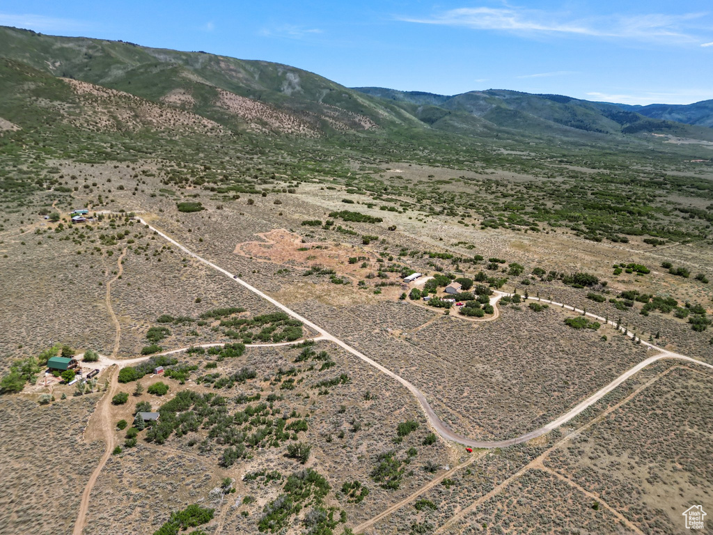 Aerial view of sparsely populated area with a desert landscape and a mountainous background