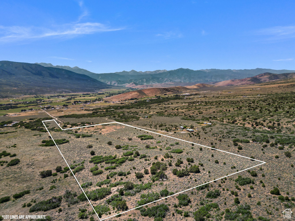 View of rural area with a mountainous background and property boundaries highlighted