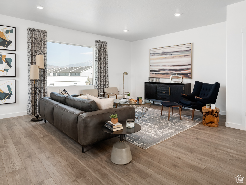 Living area with wood finished floors and recessed lighting