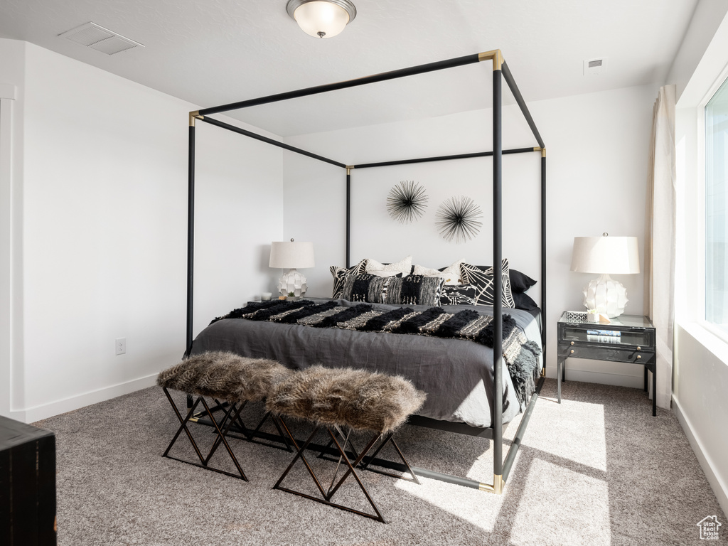 Carpeted bedroom featuring baseboards