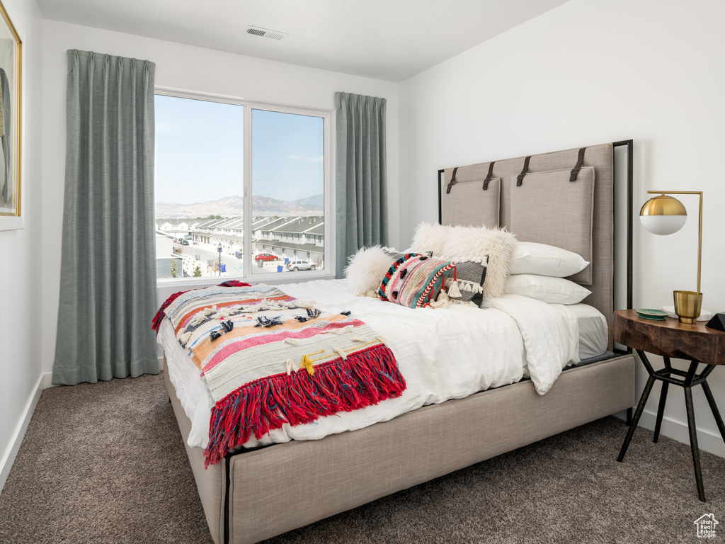 Bedroom with carpet floors and a mountain view