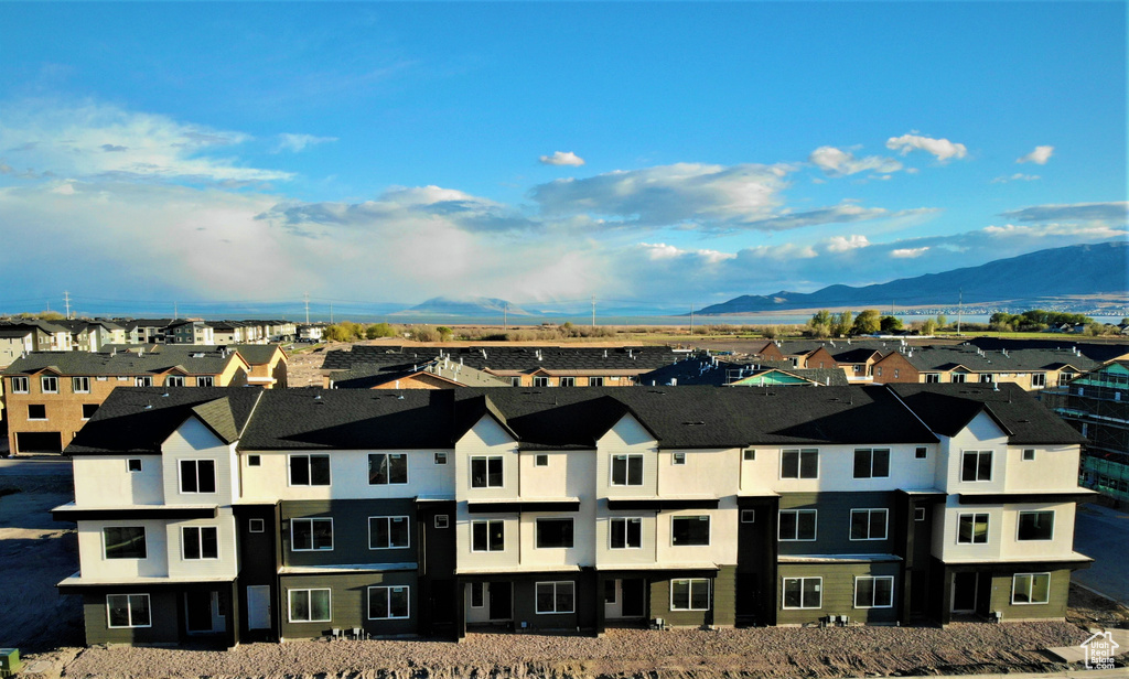 Aerial view of residential area featuring a mountainous background