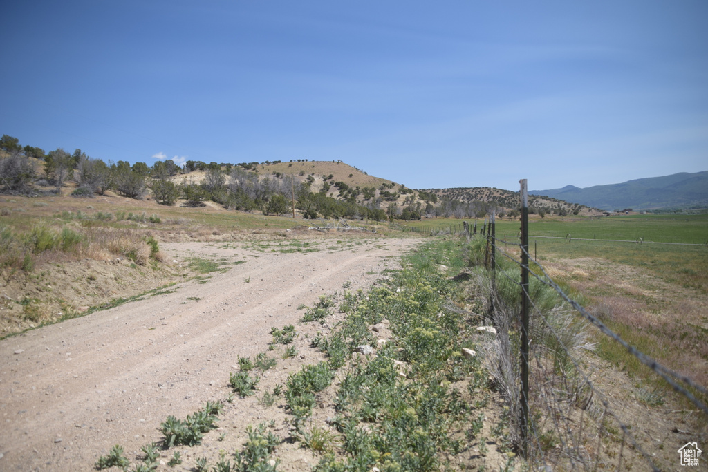 View of street with a view of rural / pastoral area and a mountain view