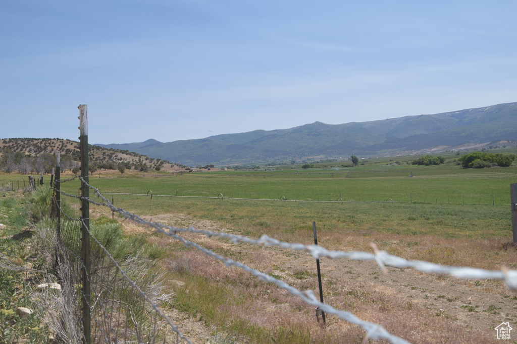 View of mountain backdrop with rural landscape and a pastoral area
