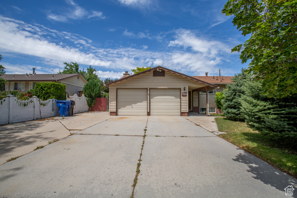 View of front of house with driveway and a garage