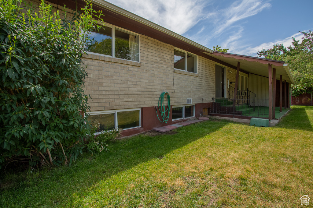 Rear view of property featuring a lawn