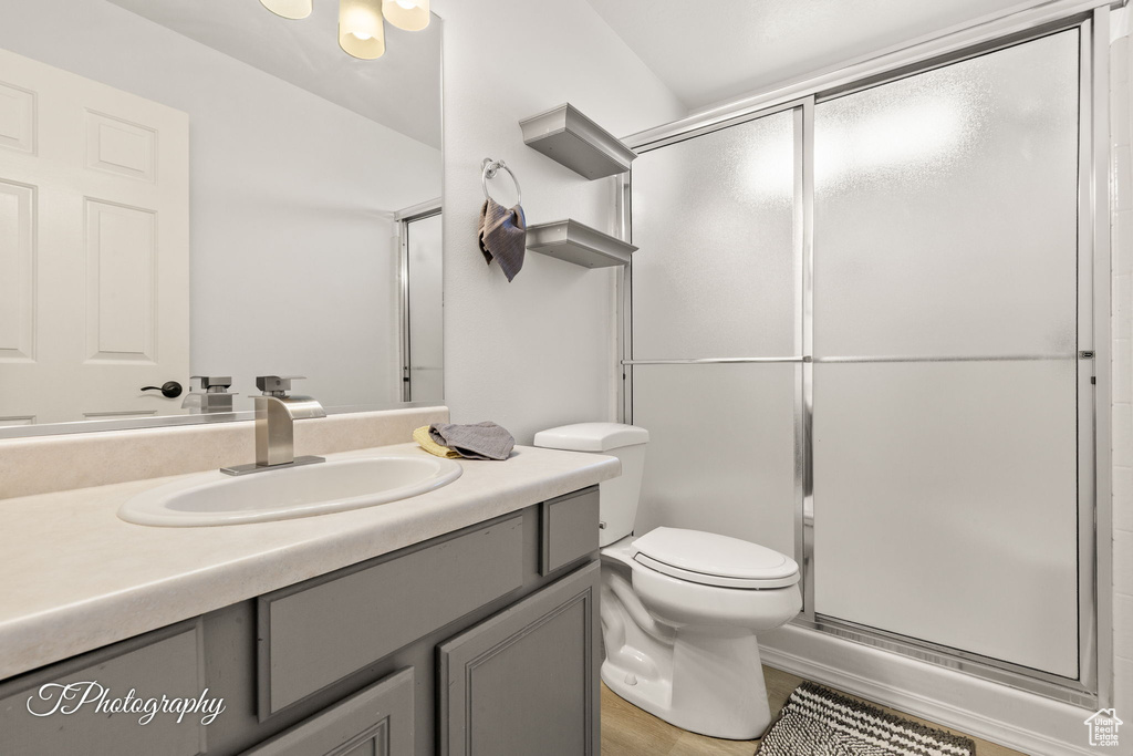 Bathroom featuring vanity and a stall shower