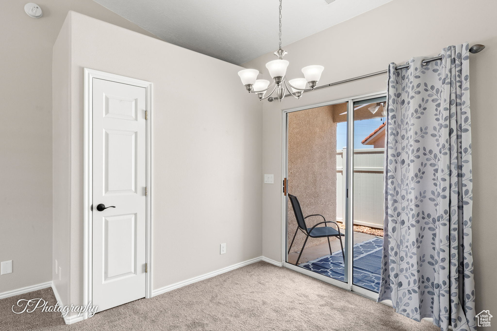 Unfurnished dining area featuring carpet floors and a chandelier