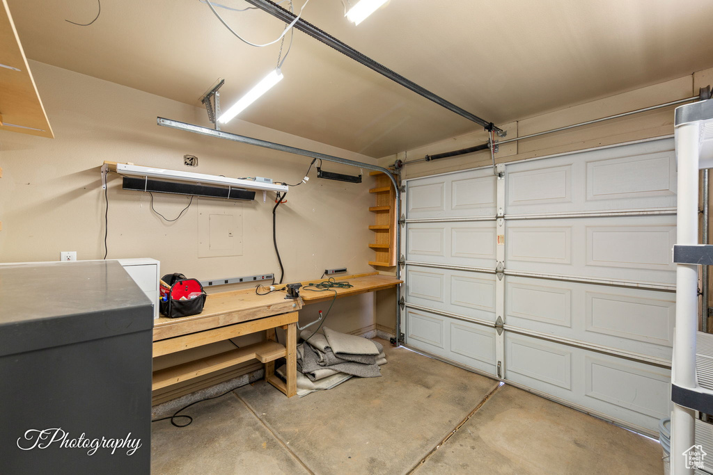 Garage with a workshop area and electric panel