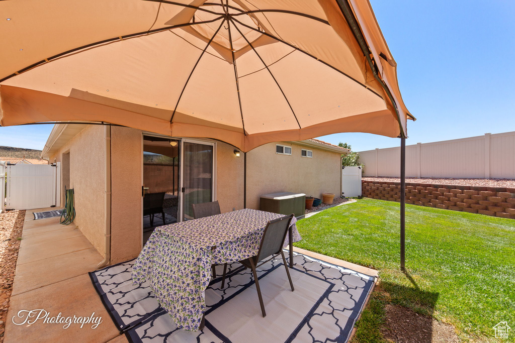 Fenced backyard with outdoor dining area and a patio area