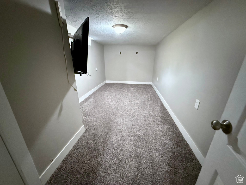 Spare room with carpet and a textured ceiling
