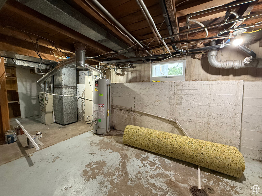 Below grade area featuring gas water heater and heating unit