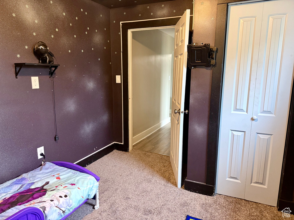 Carpeted bedroom featuring baseboards