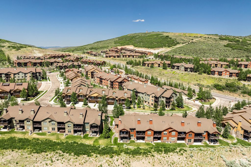 Aerial view of property's location with nearby suburban area and mountains