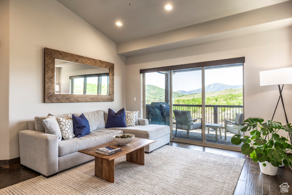 Living area featuring wood finished floors, a mountain view, lofted ceiling, and recessed lighting