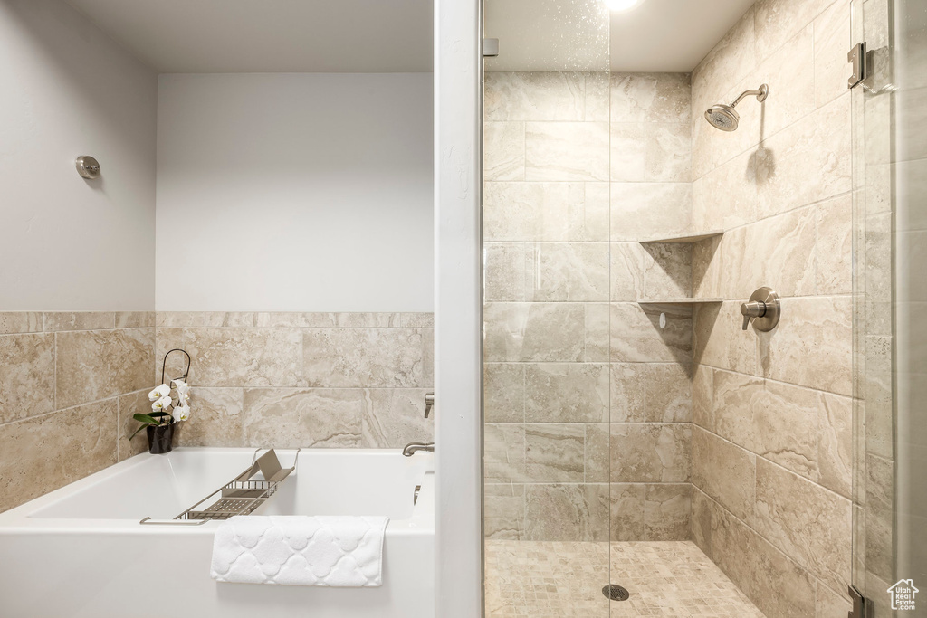 Bathroom featuring a garden tub and a stall shower
