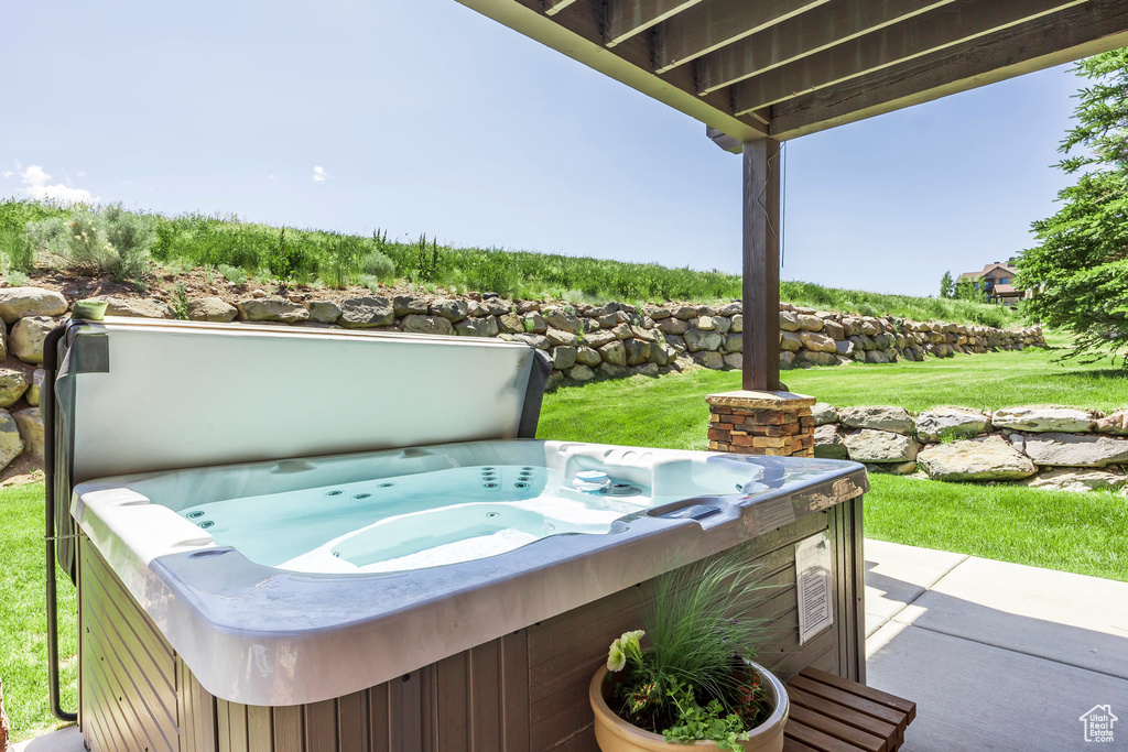 View of patio with a hot tub