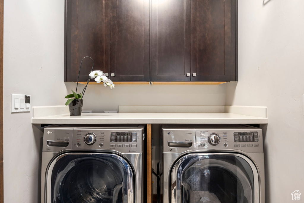 Laundry room with independent washer and dryer and cabinet space