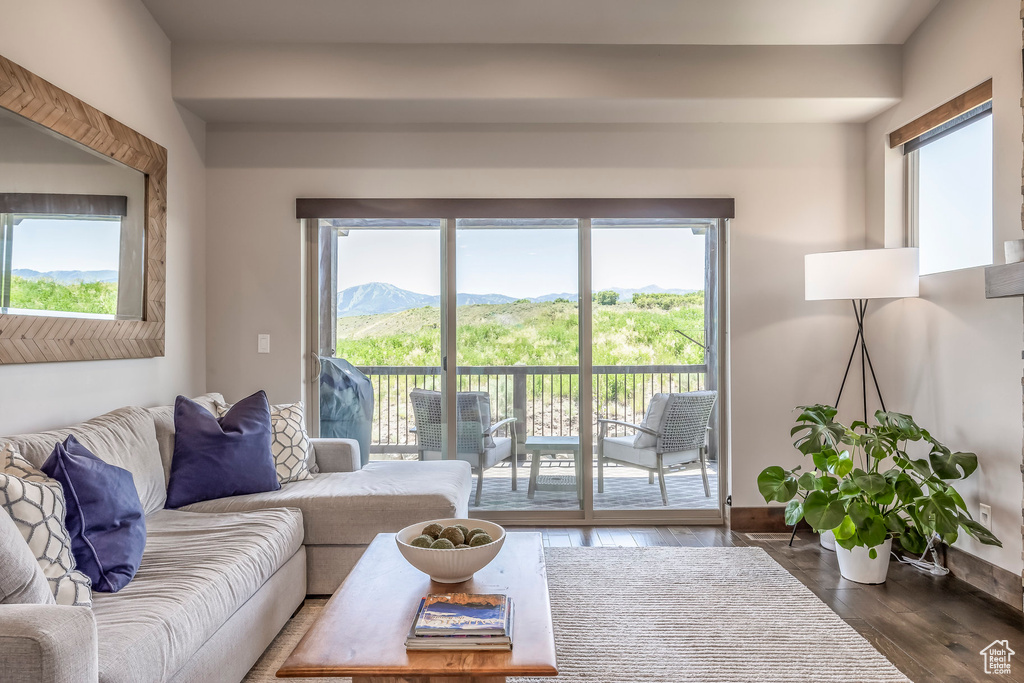 Living area with dark wood-style flooring and a mountain view