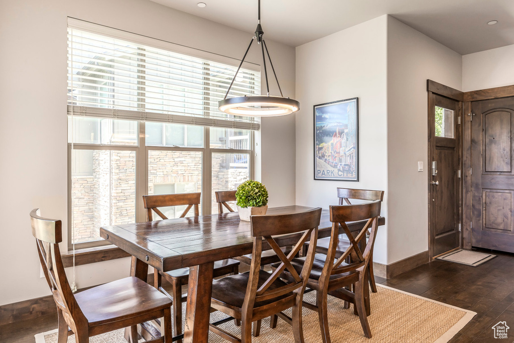 Dining room featuring dark wood-type flooring and baseboards