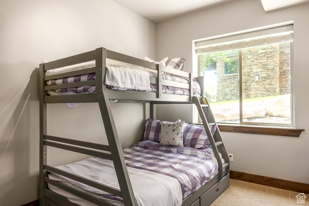 Carpeted bedroom featuring baseboards