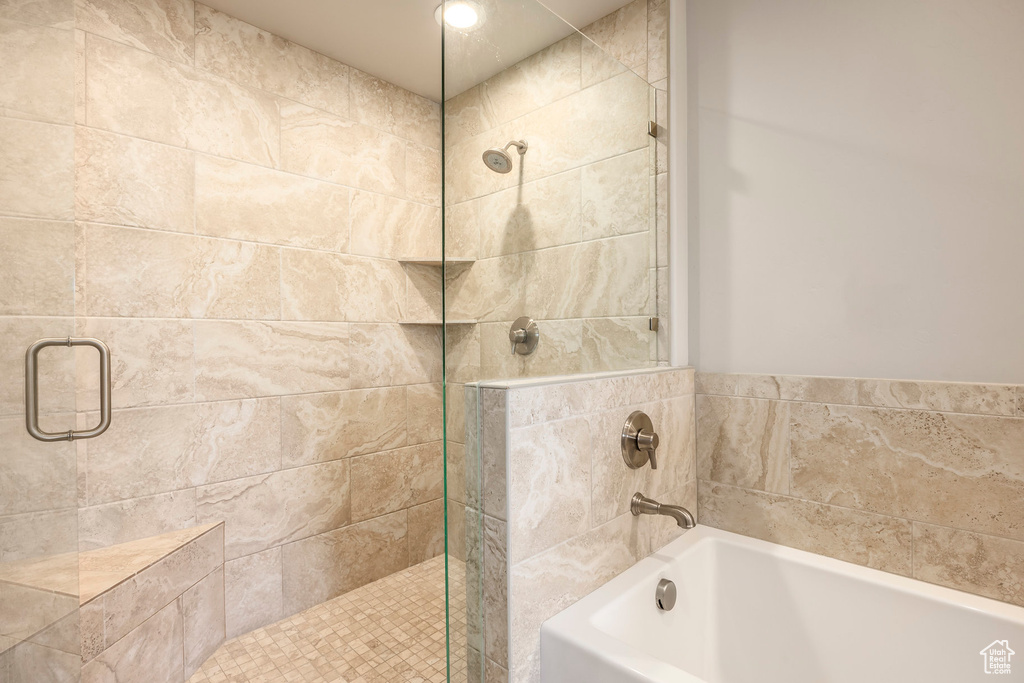 Bathroom with a stall shower and a garden tub