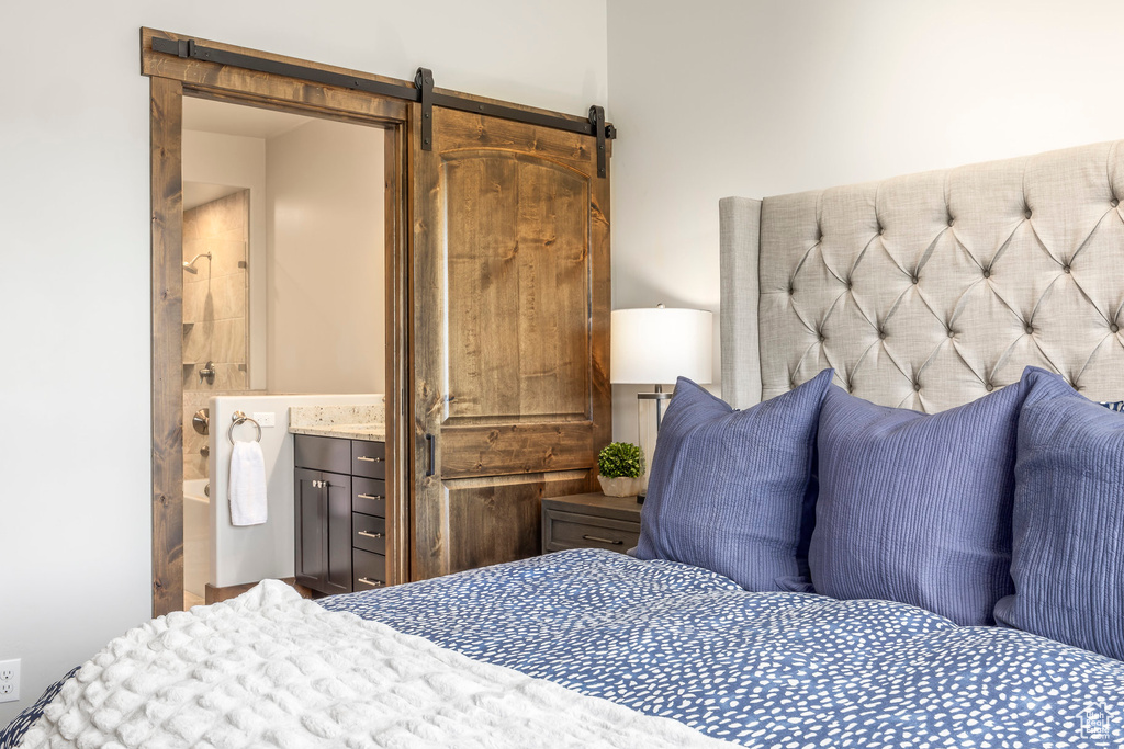 Bedroom with a barn door and ensuite bathroom