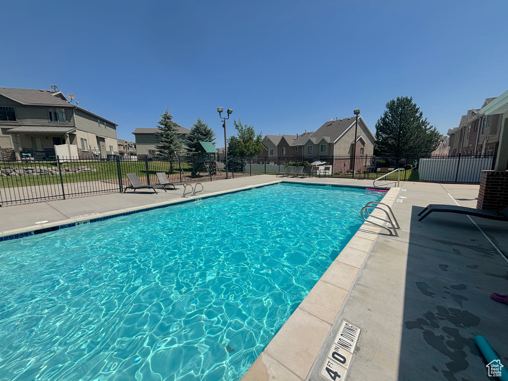 Community pool featuring a residential view and a patio