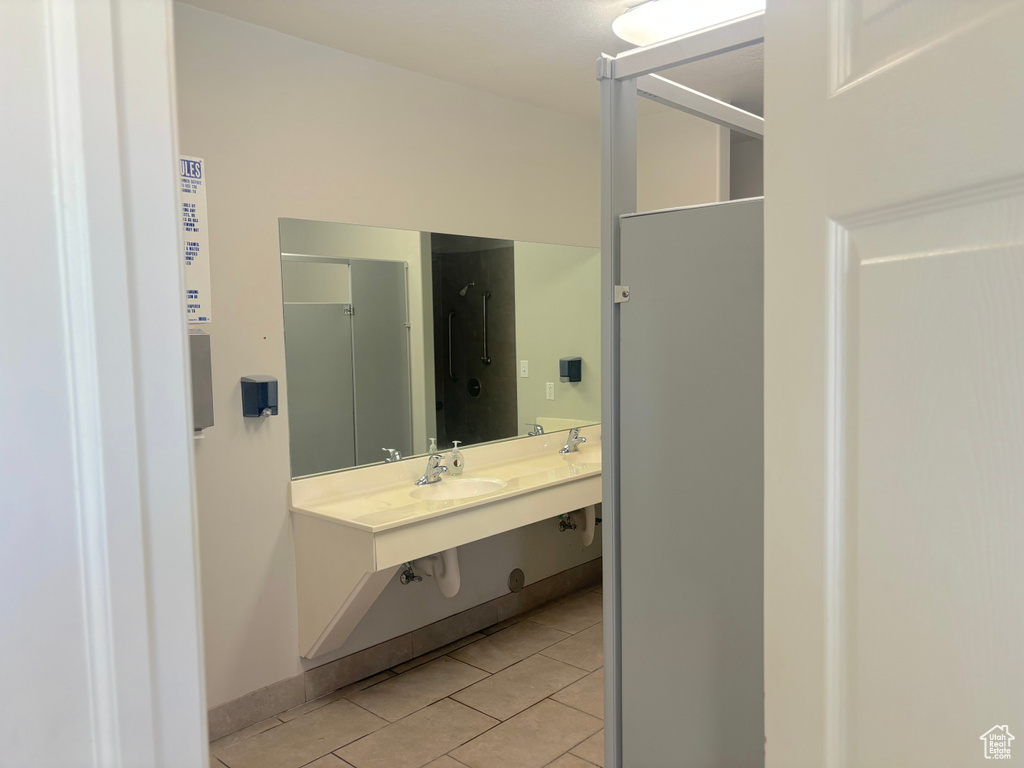 Full bathroom with tile patterned floors and double vanity