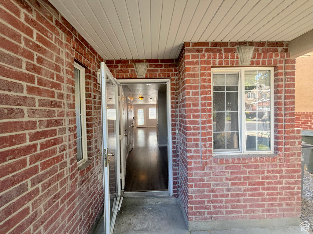 Doorway to property with brick siding