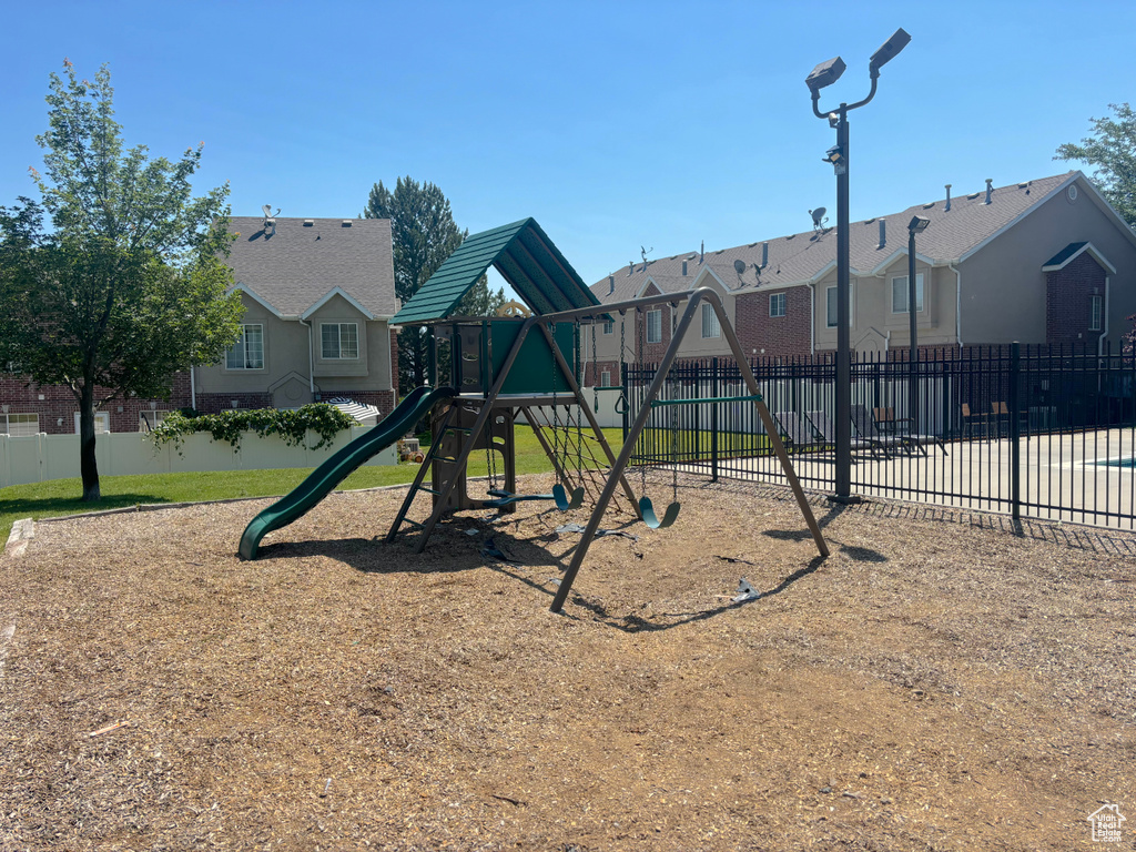 Community jungle gym with a residential view