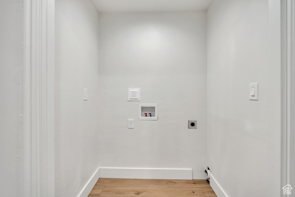 Laundry room featuring hookup for an electric dryer, light wood finished floors, and washer hookup