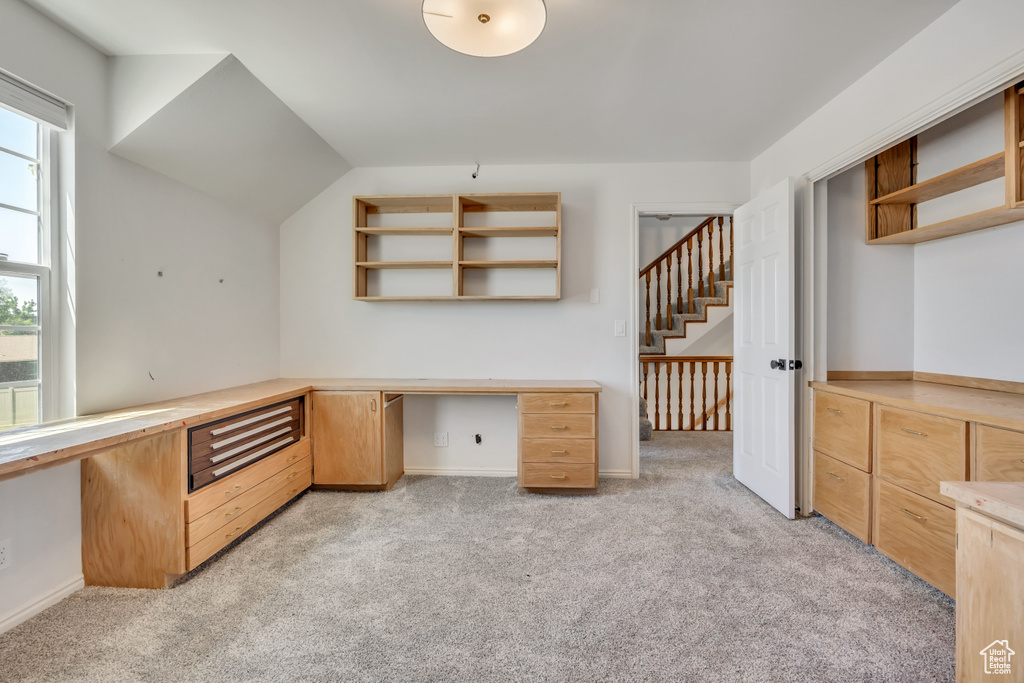 Unfurnished office featuring light carpet and built in desk