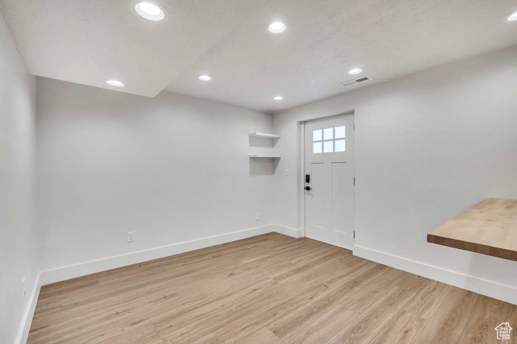 Entryway with light wood-style floors and recessed lighting