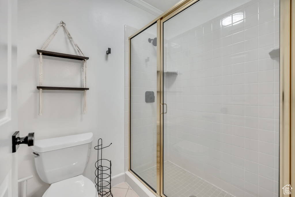 Full bathroom featuring a shower stall and toilet