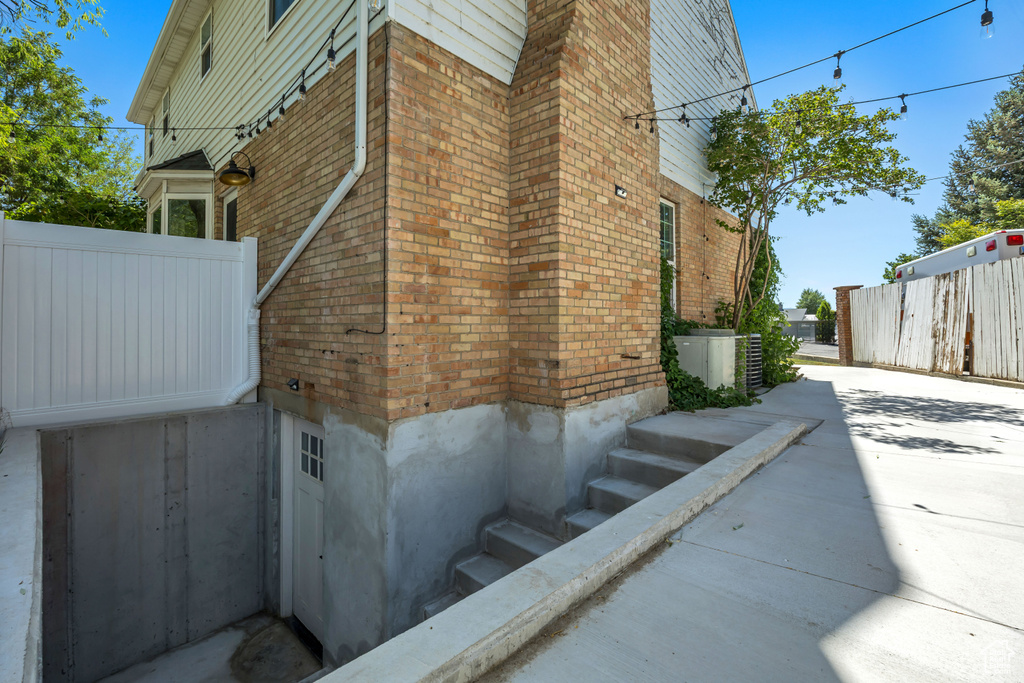 View of home's exterior with brick siding and a central air condition unit