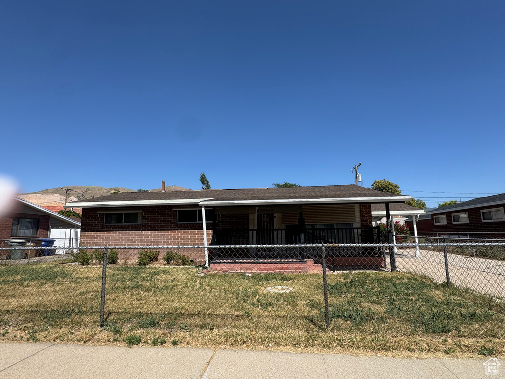Ranch-style home with brick siding and a carport