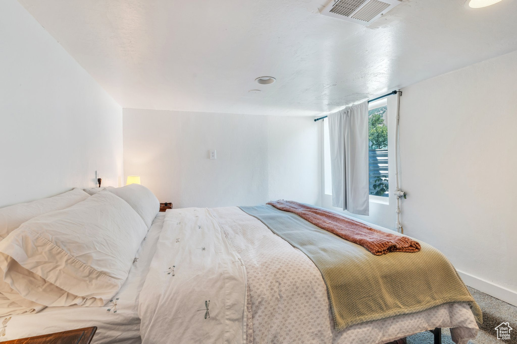Bedroom featuring baseboards and carpet floors