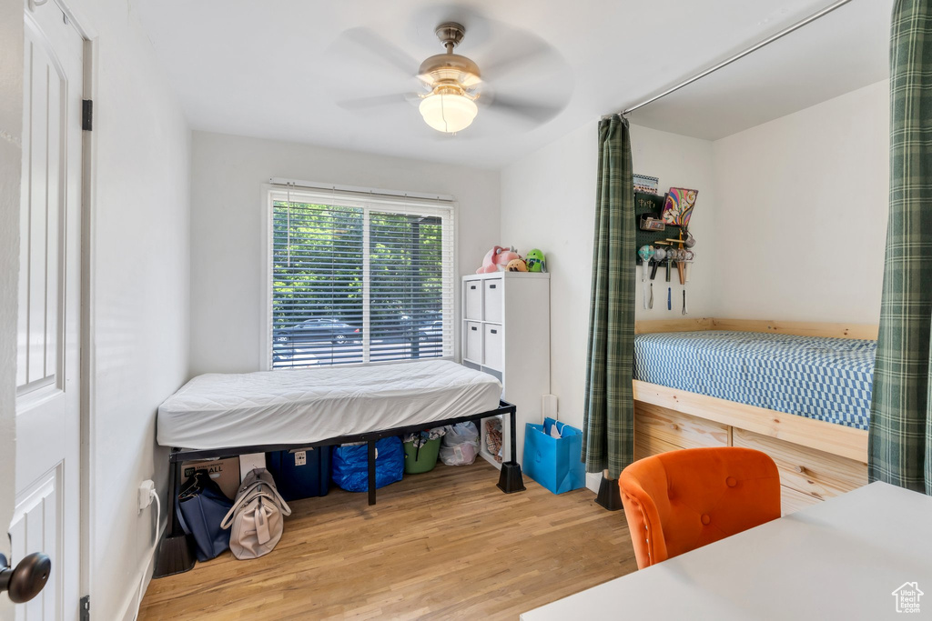 Bedroom with wood finished floors and a ceiling fan