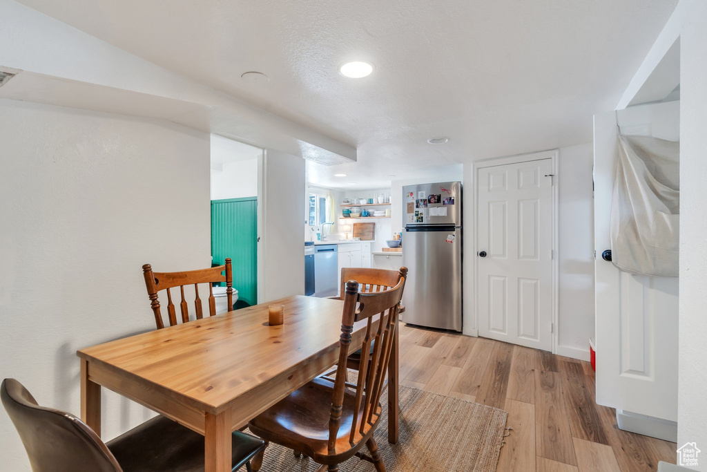 Dining space featuring light wood-style flooring and recessed lighting