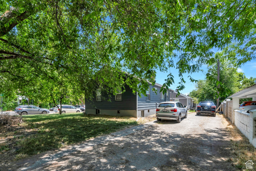 View of property exterior with asphalt driveway