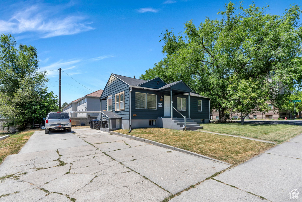 Bungalow-style home featuring driveway and a front yard