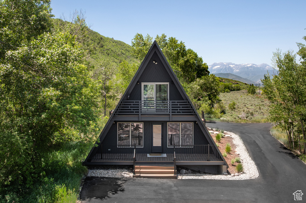 A-frame home featuring a mountain view and covered porch
