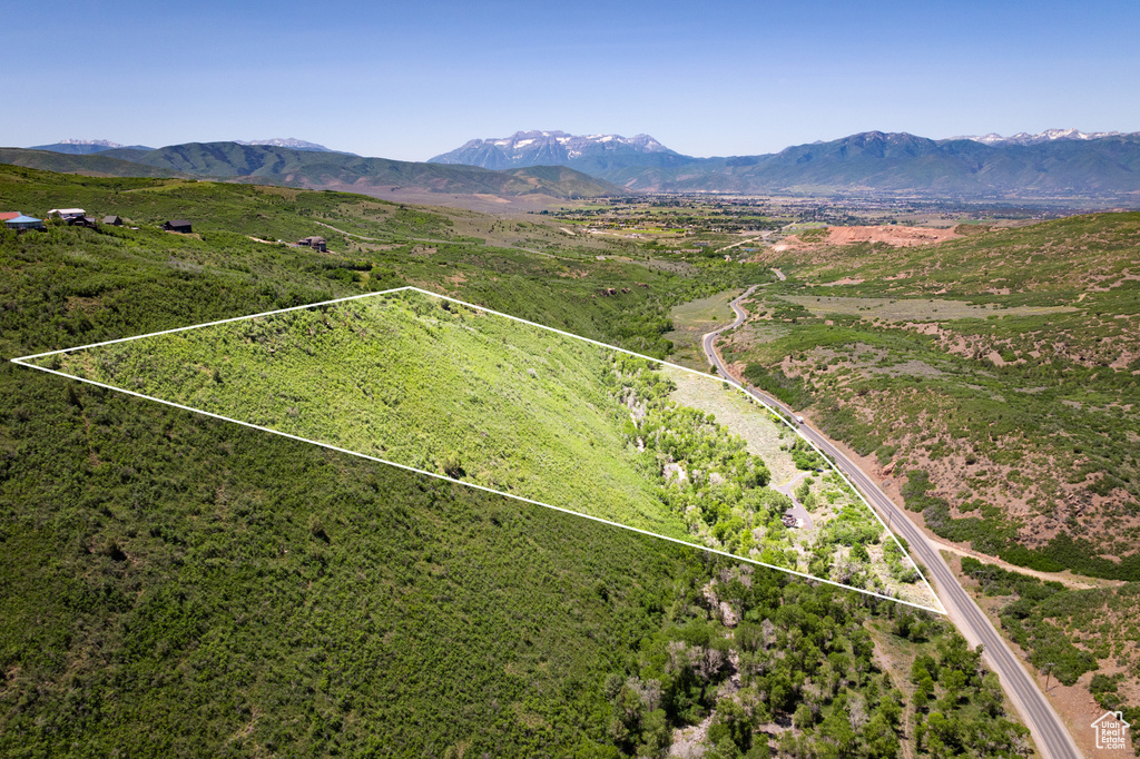 Aerial view of property's location featuring a mountainous background and property boundaries highlighted
